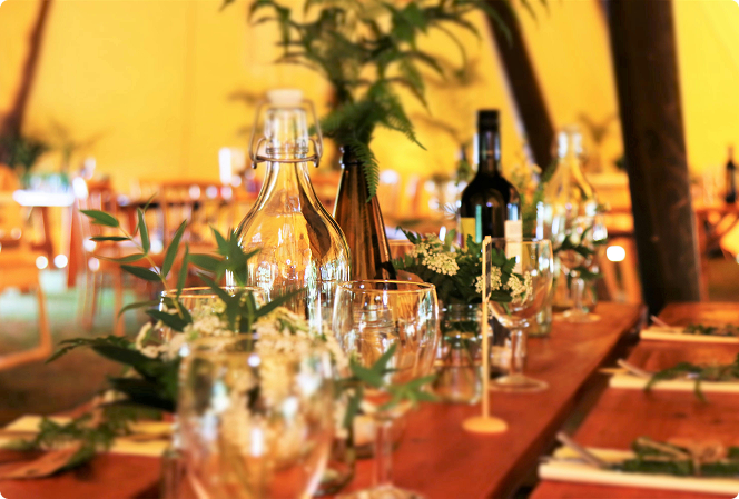 Fine Bartenders team arranging elegant cocktail setup with premium spirits and glassware